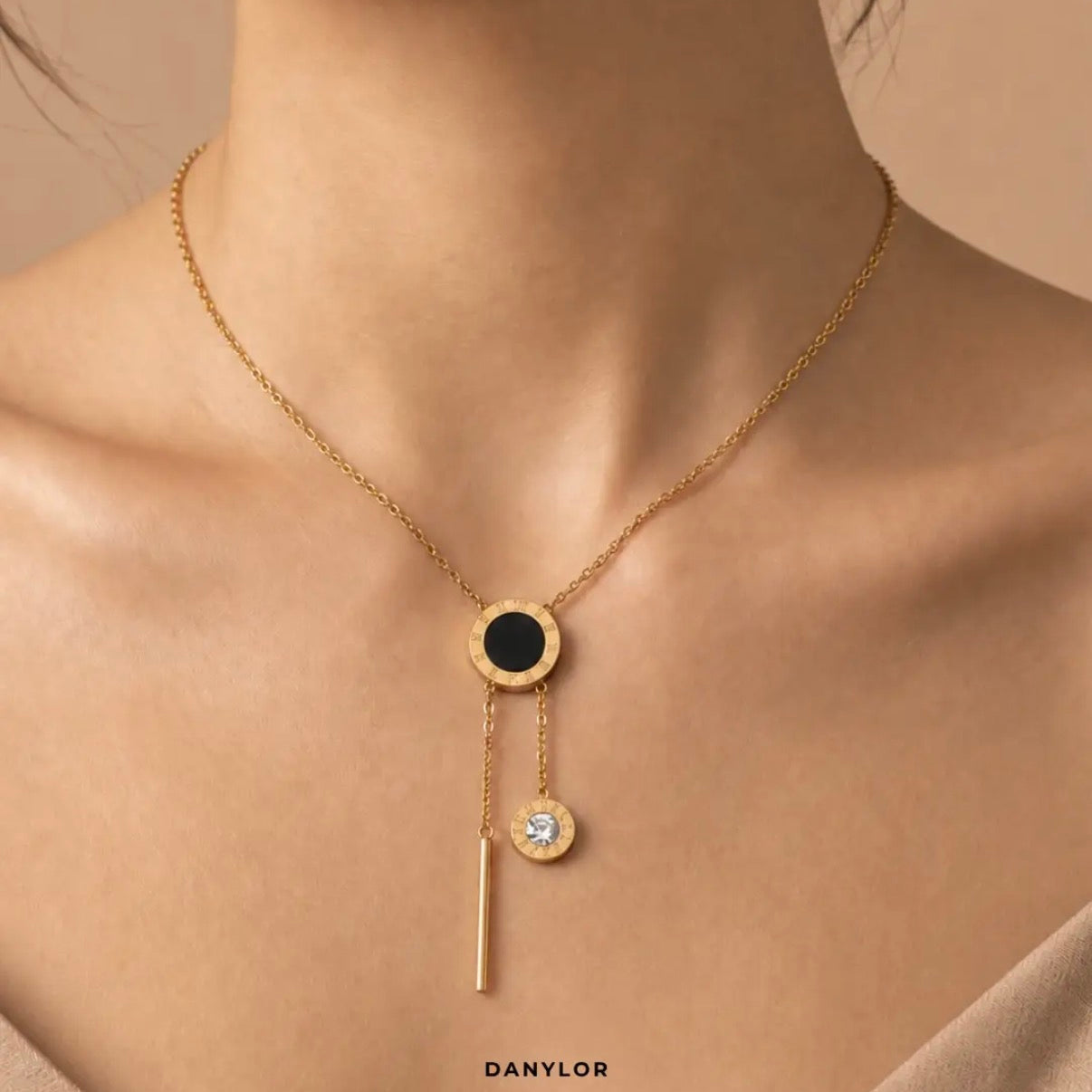 Danylor Éclipse gold-tone necklace with circular pendant and crystal drop