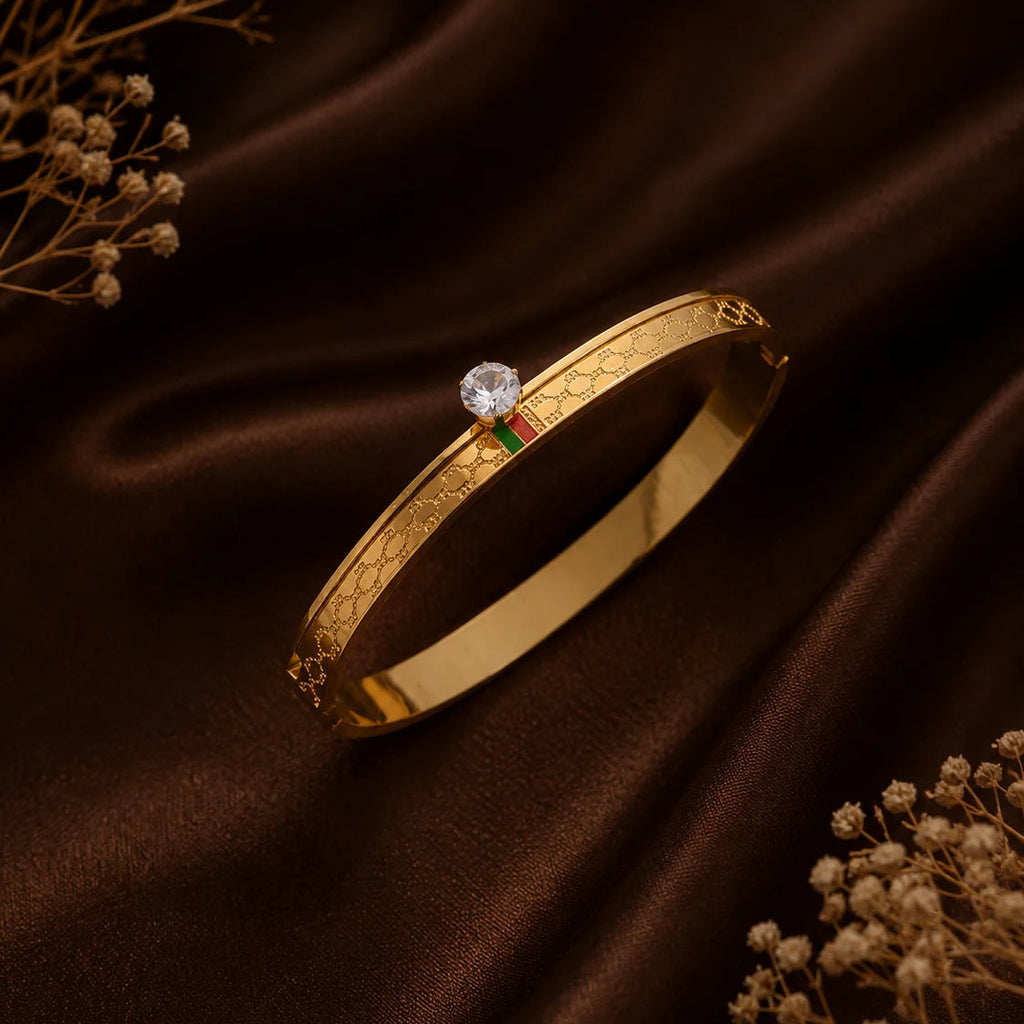 Danylor Royale gold-tone bangle with engraved details and crystal